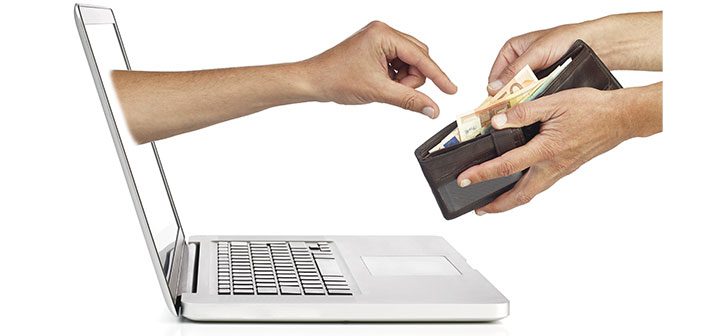 hånd der kommer ud af computerskærm snupper penge i pung